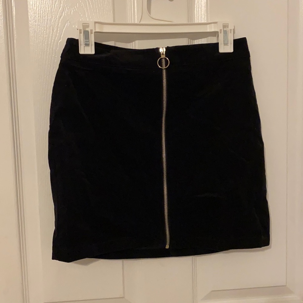 Zip up black corduroy skirt.